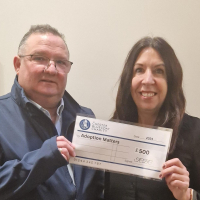Finance and Business Service Manager Karen Davies receives £500 cheque from The Chester Bluecoat CEO Mike Jenkins