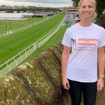 Susy showing off her Adoption Matters t-shirt by Chester Racecourse